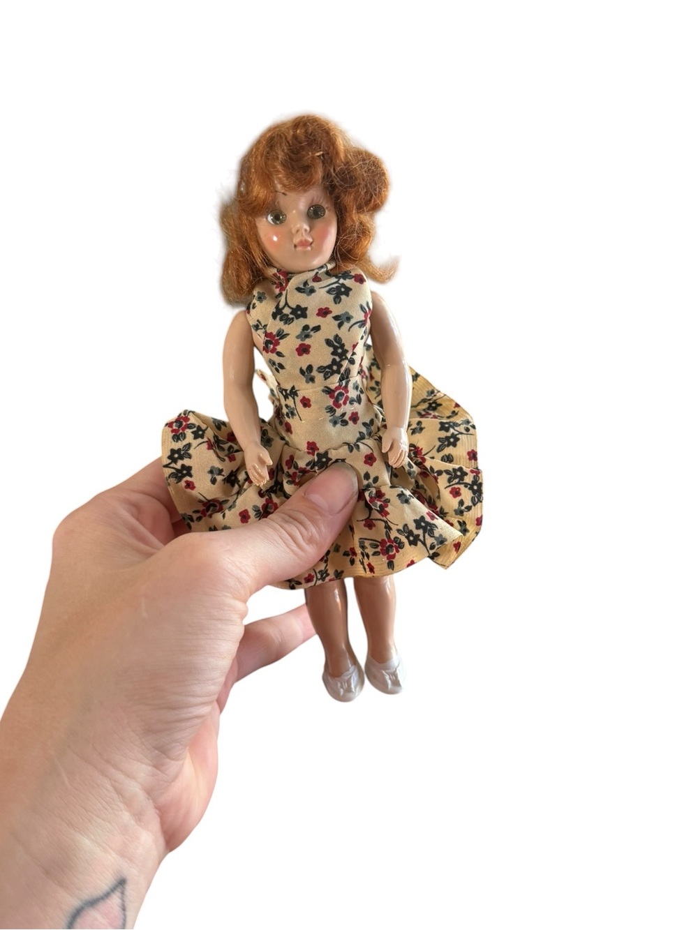 Vintage plastic doll in floral dress